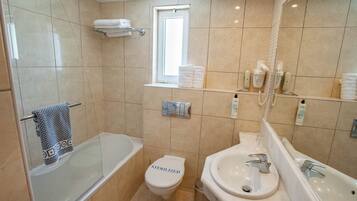 A modern bathroom with a bathtub, toilet, and sink.