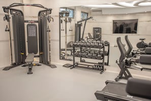 A gym with exercise equipment, a bench, and a mirror. - Rhodos Horizon Marina (Rhodes)