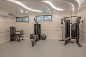 A modern gym with weight machines, a bench, and a medicine ball. - Rhodos Horizon Marina (Rhodes)