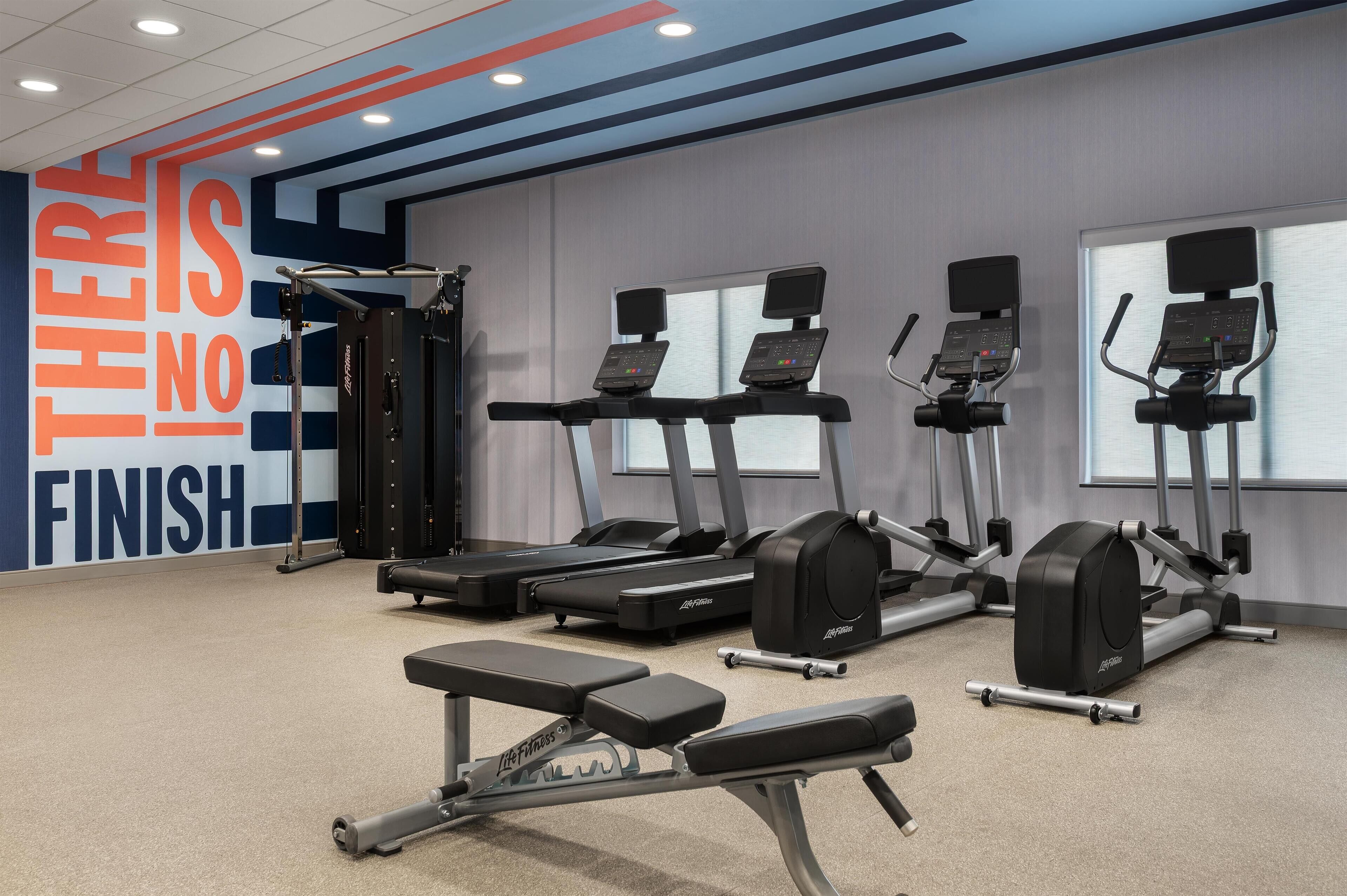 A gym with treadmills, ellipticals, and weight machines.