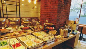 A buffet with various food items and utensils. - Graces Hotels (Inzai)
