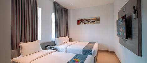 A hotel room with two beds, a TV mounted on the wall, and a painting above the TV.