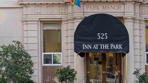 The exterior of Park Manor Inn at the Park, featuring a classic architectural style with a prominent arched entrance and a large number '525' sign above the door. - Comic Con 2025, San Diego, Inn at the Park 32BR (San Diego)