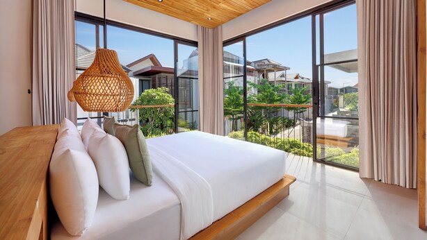 A modern bedroom with a large bed, wooden ceiling, and large windows offering a view of the neighborhood. - Villa Lila (Canggu)