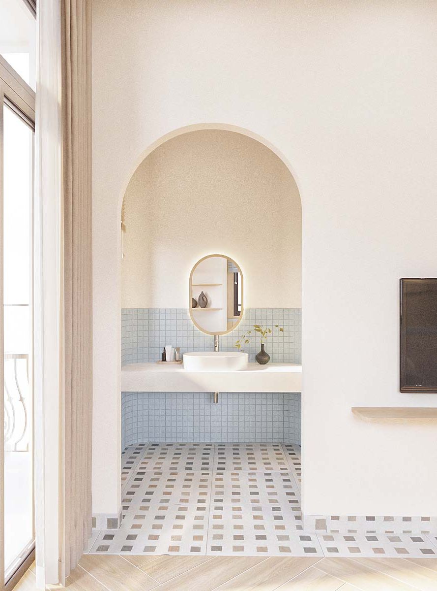 A bathroom with a white sink, a mirror, and a tiled floor.