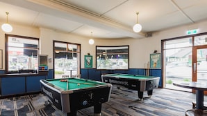 A pool table area with two pool tables, a bar, and a view of the street outside. - The Lakes Hotel, Rosebery (Rosebery)