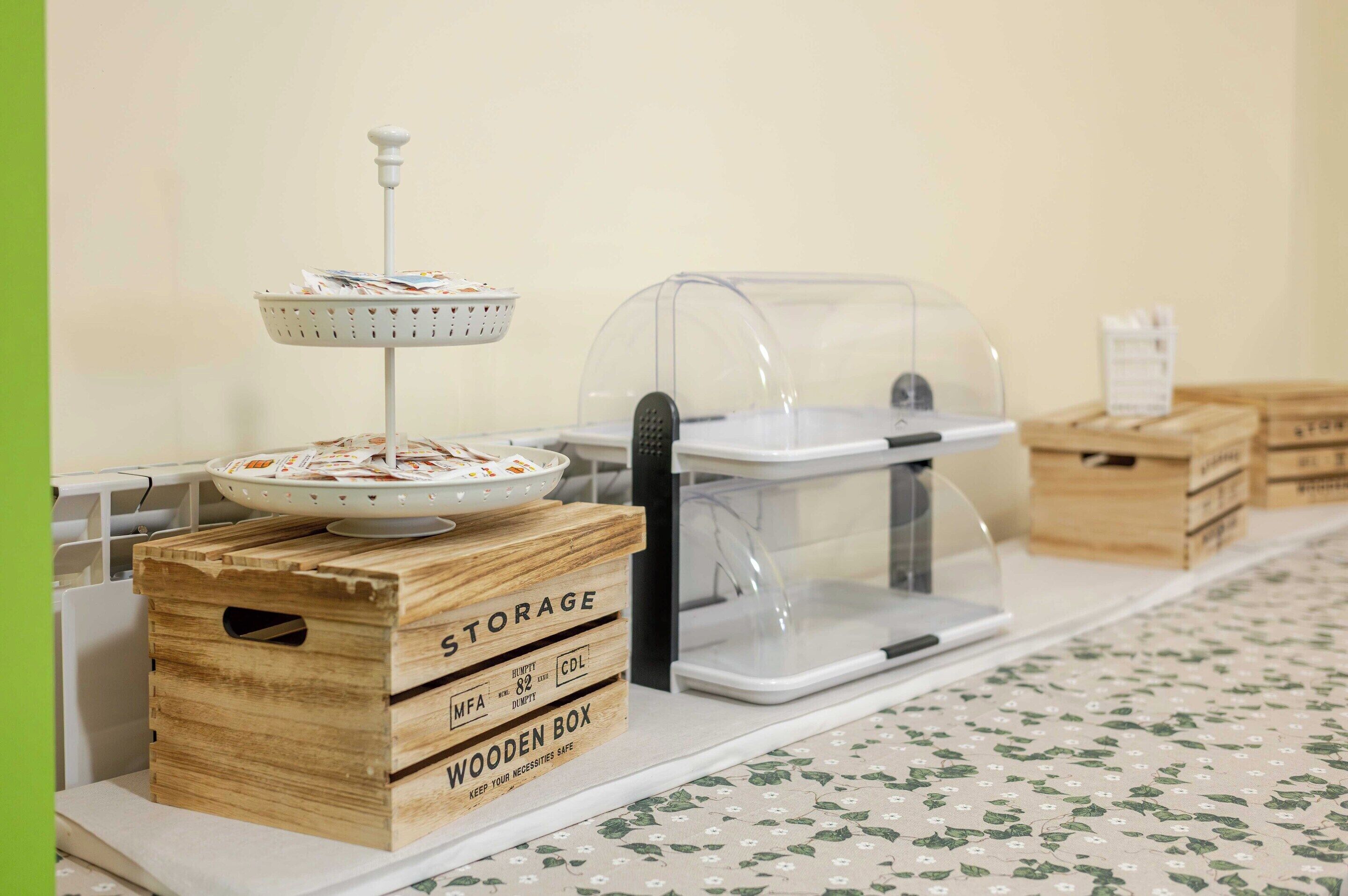 A kitchen area with a wooden box labeled 'STORAGE' and a coffee machine.