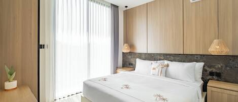 A modern bedroom with a large bed, wooden paneling, a stone accent wall, and a ceiling-mounted air conditioner.