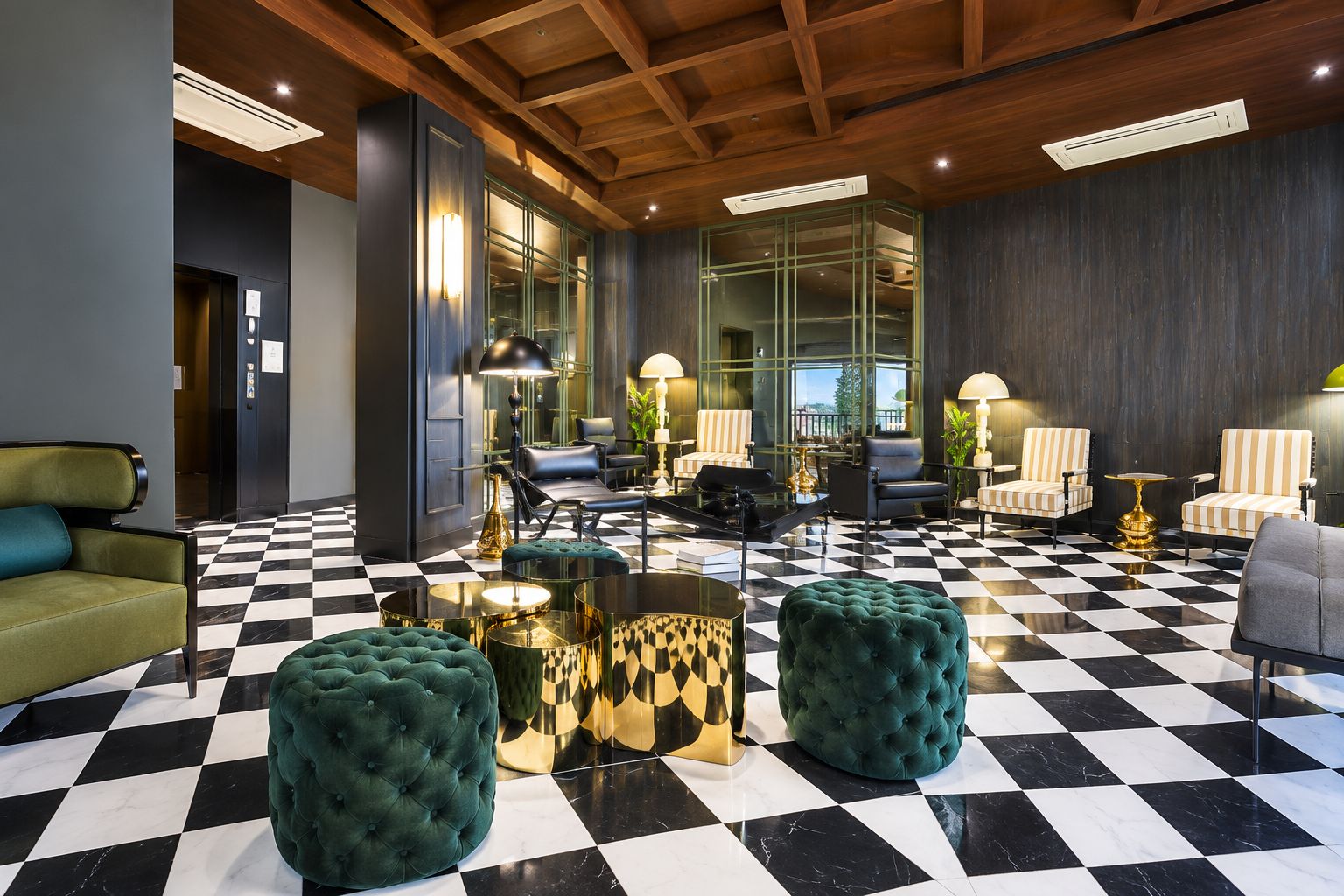A lobby with a checkered floor, leather sofas, and a glass partition wall.