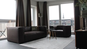 A modern living room with a sofa, a coffee table, and a TV stand. - Trompstraat (Eindhoven)