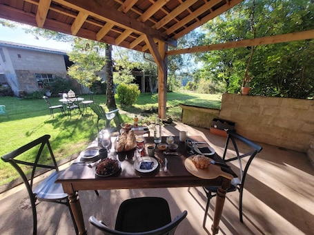 Outdoor dining. Chambre d'hôtes des Marchands in an old village hotel dating from 1934