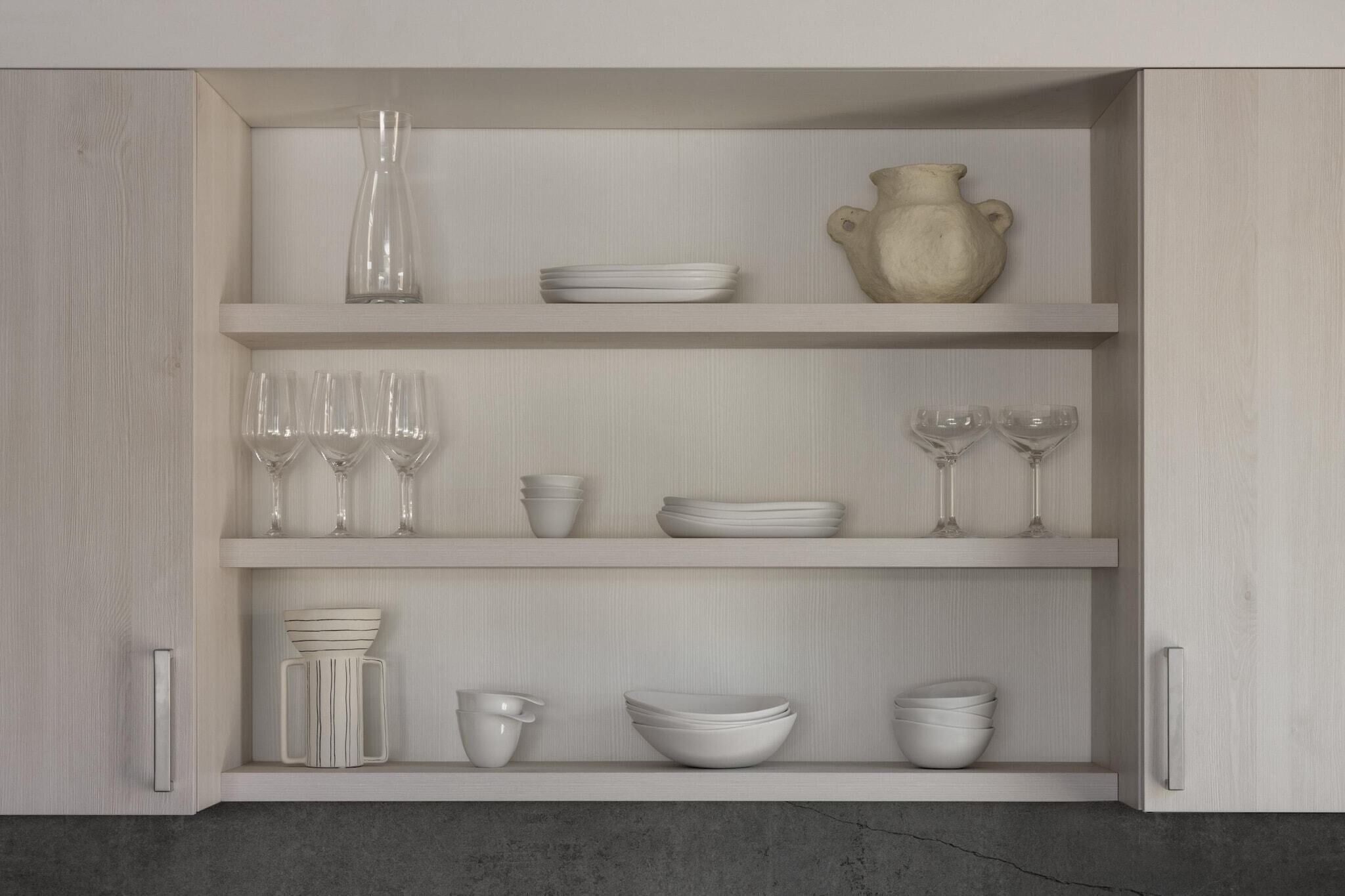 Un meuble de cuisine doté de trois étagères, chacune contenant divers ustensiles et accessoires de cuisine.