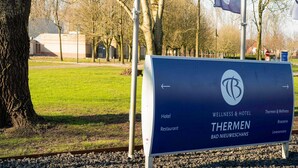 A sign for 'Thermen' indicating a hotel, restaurant, wellness & hotel, and brasserie.