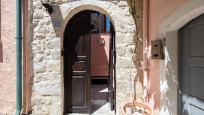 An arched doorway with a number '22' above it, leading into a building with a tiled floor. - Fortezza Sea Breeze Anne-2BR with view (Rethymno)