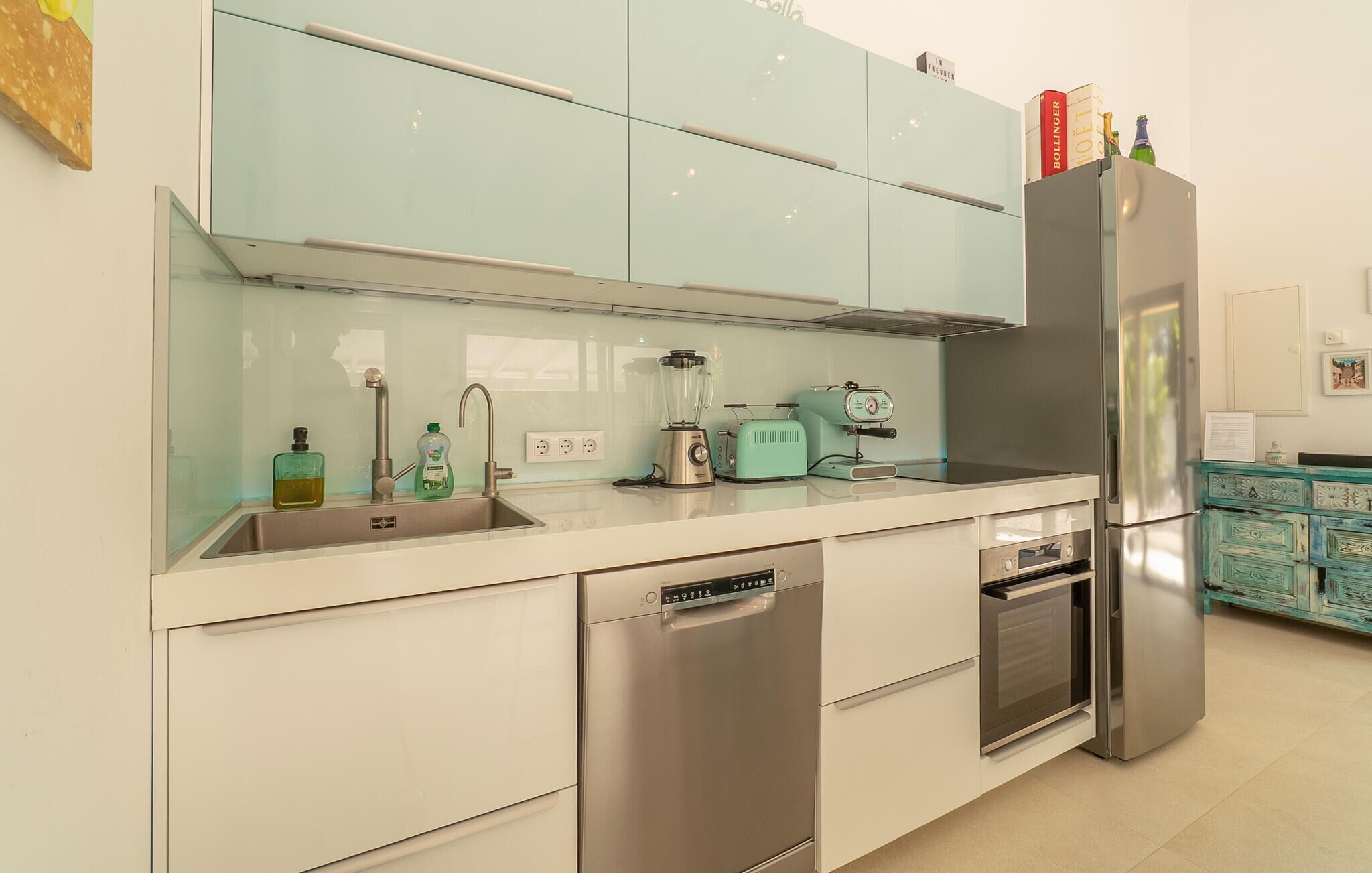 A modern kitchen with stainless steel appliances, a dishwasher, and a built-in oven.