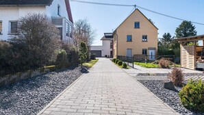 A pathway leading to a building with a sloped roof and a small window. - Holiday Apartment 'Eifel im Herzen' with Private Terrace, Garden & Wi-Fi (Hambuch)