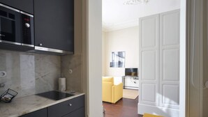 A modern kitchen with a Bosch microwave and a marble countertop.