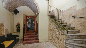 A stone staircase leading to a door with a metal railing. - Nice home in Modica with WiFi (Modica)