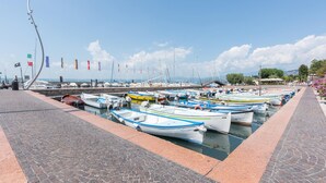 A marina with small boats docked along a paved walkway. - 2 bedroom beautiful home in Cisano di Bardolino (Cisano di Bardolino)