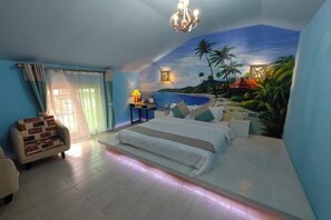 A bedroom with a bed, a chair, a nightstand, and a mural of a tropical beach scene. - Kyushu Chain Inn (Observation Store) (Renhua)