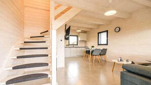 A modern interior with a staircase, a dining area, and a kitchen. - 2 bedroom amazing home in Dziwnówek (Dziwnówek)