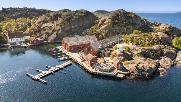 A coastal building with a dock, surrounded by rocky terrain and clear skies. - Awesome home in Søgne with WiFi (Søgne)