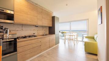 Deluxe Apartment, Sea View | Private kitchen | Fridge, microwave