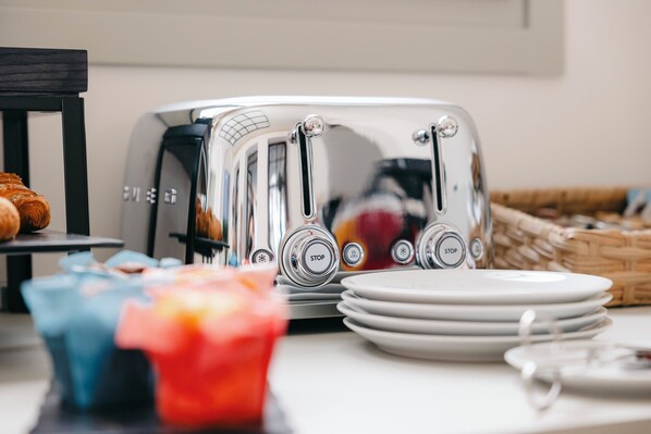A kitchen counter with a toaster, plates, and a basket.