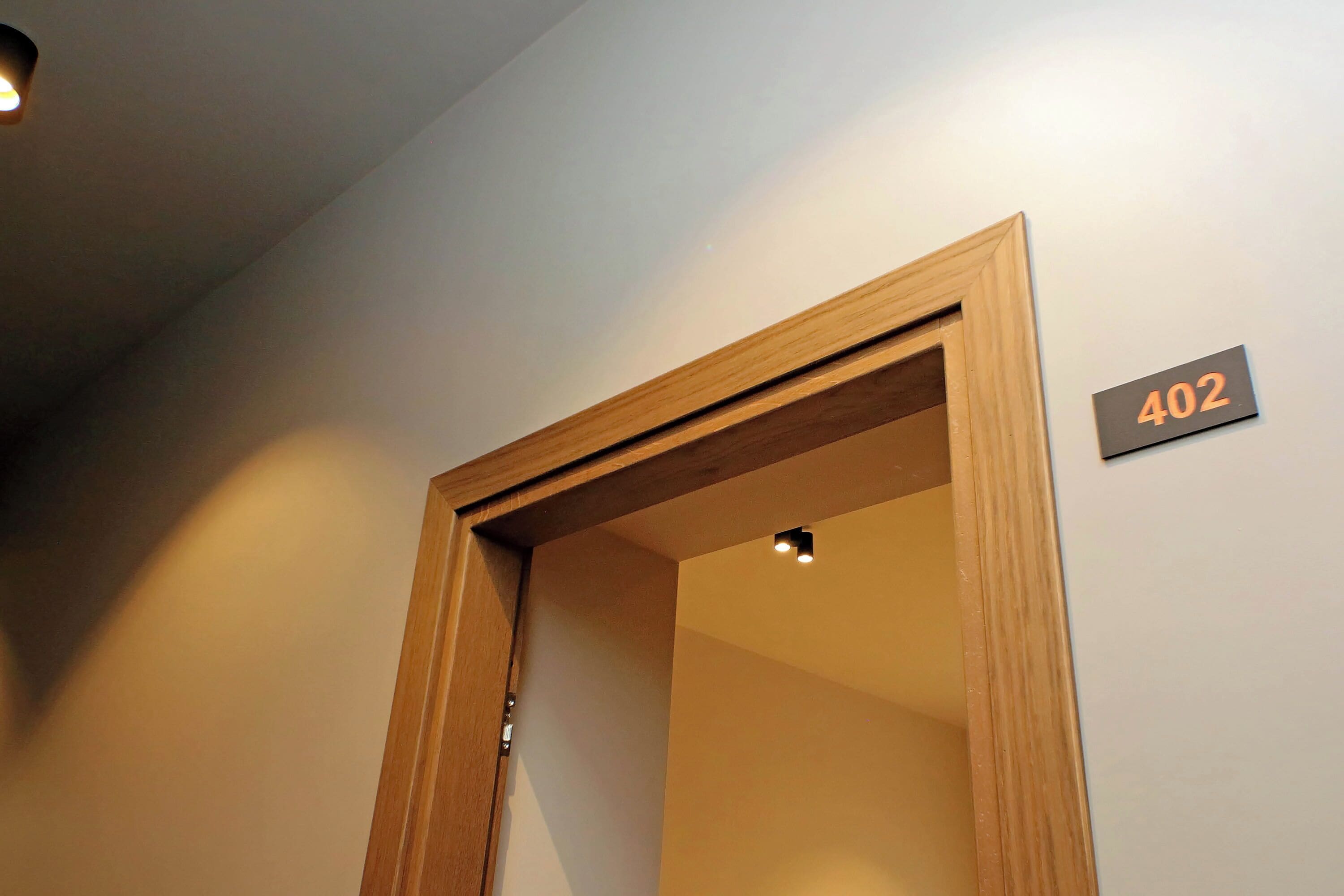 A door frame with a number sign '402' on the wall.