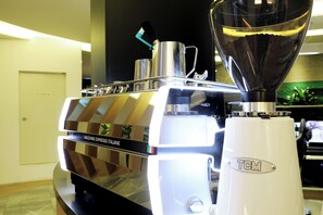 A coffee machine with a digital display and a water tank. - HOTEL AURORA (Gimpo)
