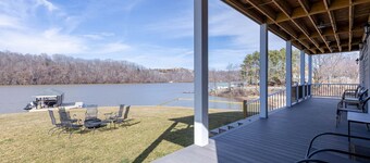 Modern lakefront home with wraparound decks, firepit, and stunning water views on both levels.