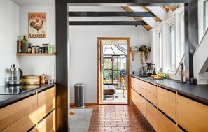 Fridge, stovetop, dishwasher, coffee/tea maker