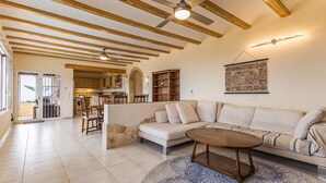 A spacious living room with a large sectional sofa, a wooden coffee table, and a patterned rug. - Amazing home in Denia (Denia)