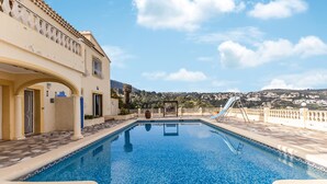 A swimming pool with a view of a hillside town. - Amazing home in Denia (Denia)
