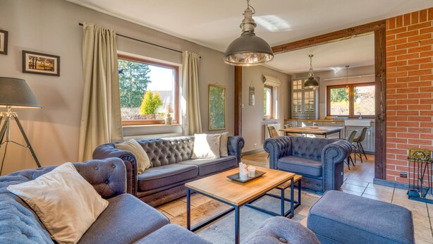 A spacious living room with a sofa set, a coffee table, and a dining area with a kitchen in the background. - Beautiful home in Olsztynek (Olsztynek)