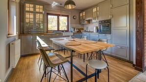 A spacious kitchen with a central island, modern appliances, and ample natural light. - Beautiful home in Olsztynek (Olsztynek)