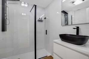 Shower, hair dryer, towels, toilet paper