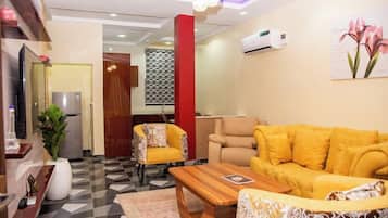 Deluxe Apartment, Balcony, City View | Living area | Flat-screen TV