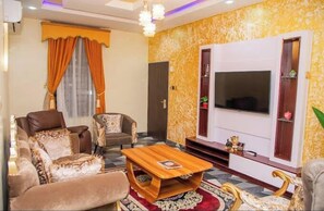 Deluxe Apartment, Balcony, City View | Living area | Flat-screen TV