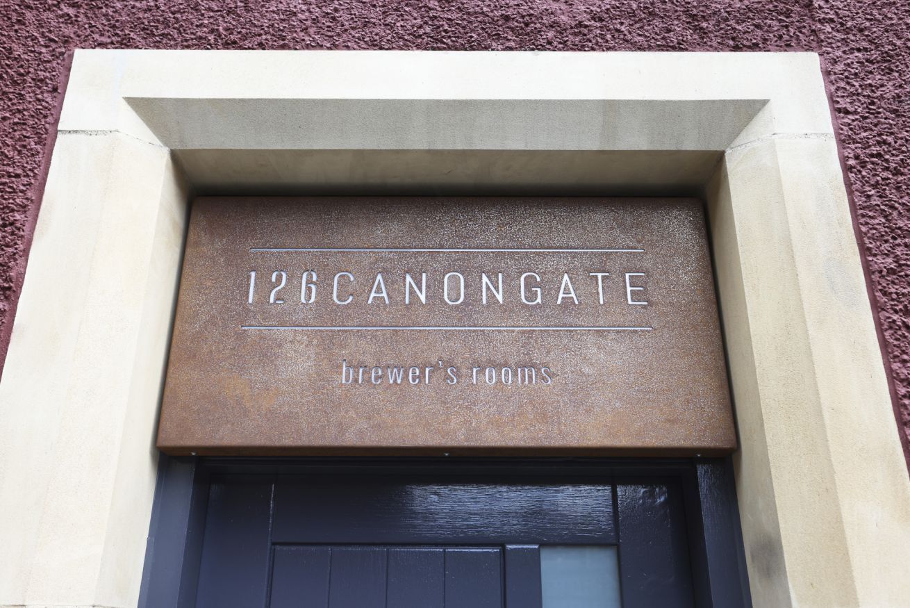 A sign with the text "126 CANONGATE BREWER'S ROOMS" above a door.