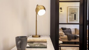A modern living room with a marble coffee table, a gold floor lamp, a grey mug, and a book titled 'Strathspey'. - Locker Room:  Stylish 2bed w/City Views-3rd floor (Edinburgh)