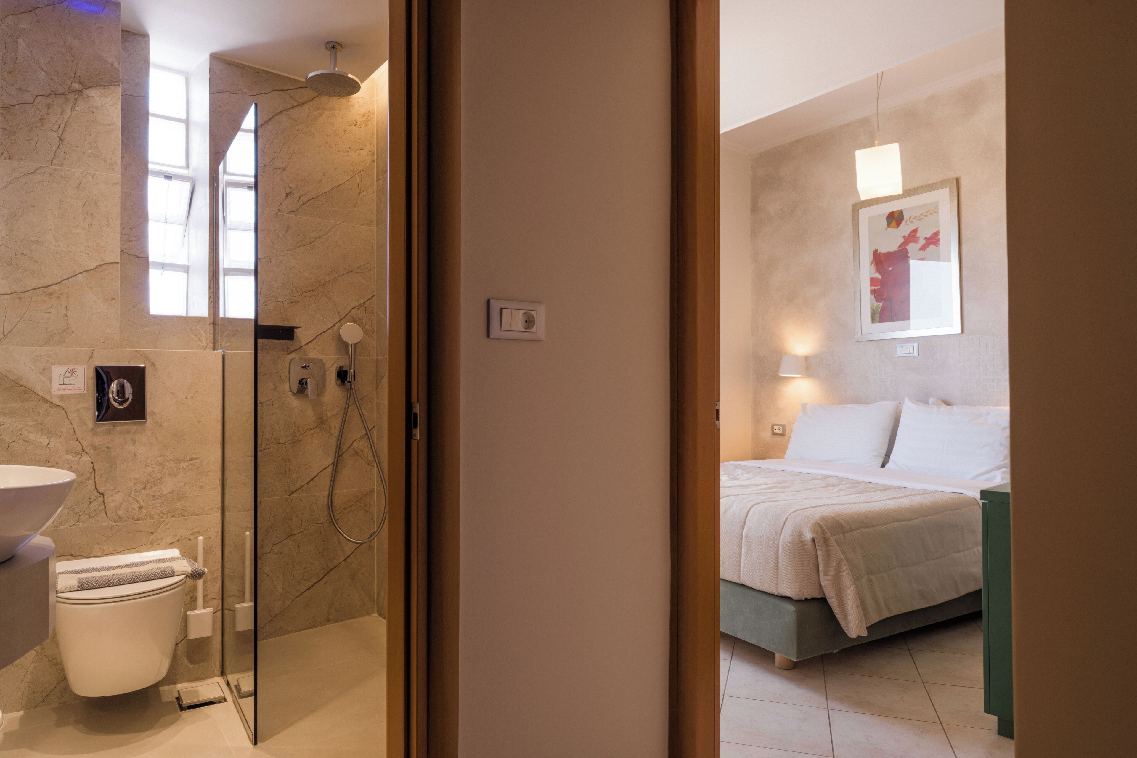A bathroom with a toilet, sink, and shower.