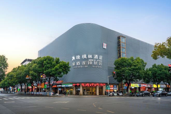 A large building with a curved facade and signage indicating it is a hotel.