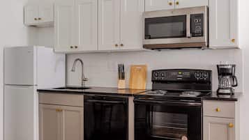 Fridge, microwave, coffee/tea maker, cookware/dishes/utensils