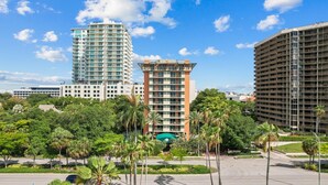 A modern hotel complex with multiple high-rise buildings, surrounded by lush greenery and a well-maintained landscape.