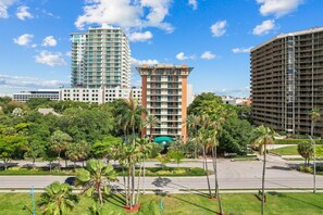 A modern hotel complex with multiple high-rise buildings, surrounded by lush greenery and a well-maintained landscape.