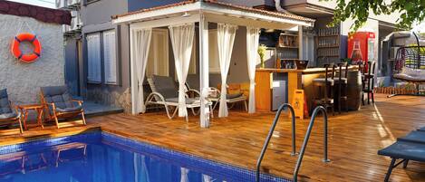 Seasonal outdoor pool, open 9:00 AM to 9:00 PM, pool umbrellas