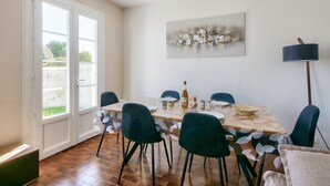 A dining area with a table, chairs, and a lamp.