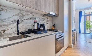 Estudio superior, vistas a la ciudad | Cocina privada | Frigorífico, microondas, horno y placa de cocina