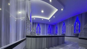 A modern hotel lobby with a marble floor, a curved ceiling, and decorative blue lighting. - Snowland Otel Sarikamis (Sarikamis)